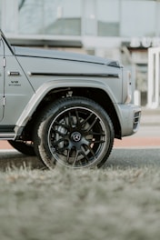 a grey jeep parked on the side of the road