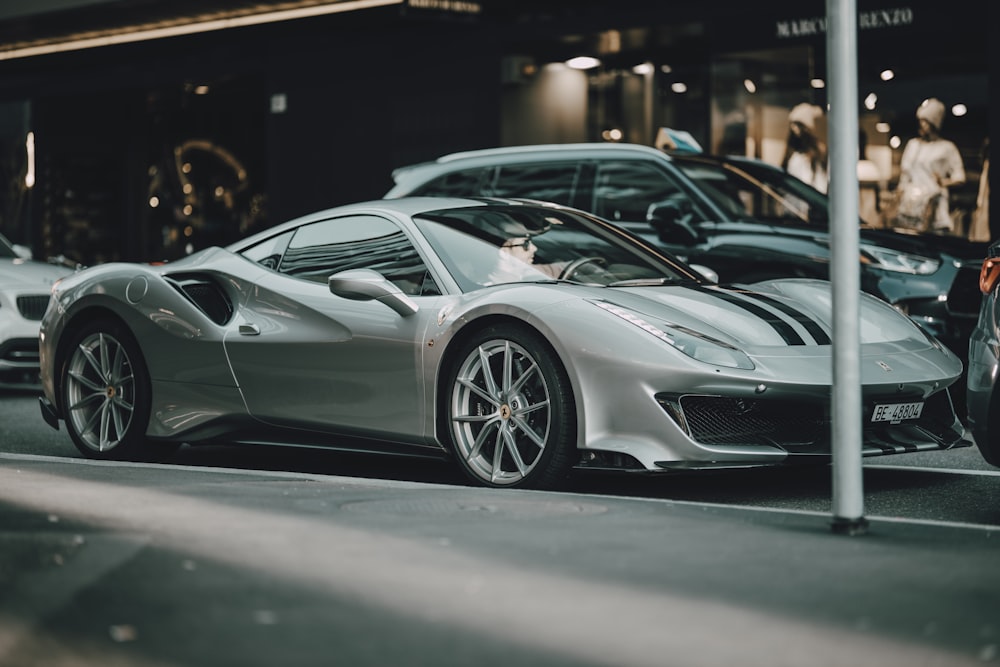 a silver sports car parked on the side of the road