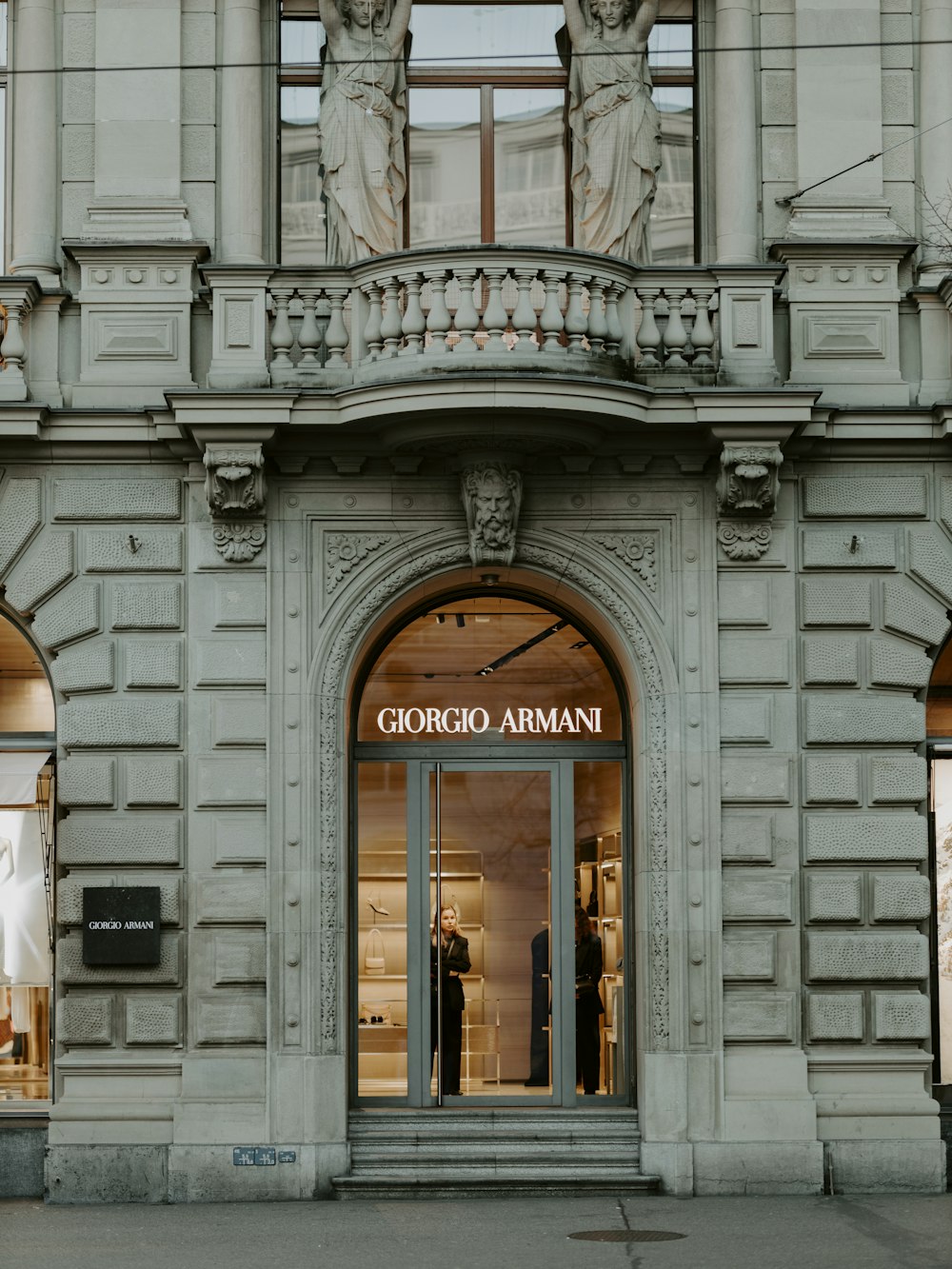 a store front with mannequins on the windows