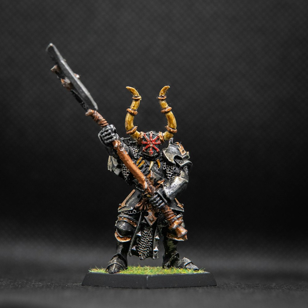 a painted warhammer with a rifle and two horns