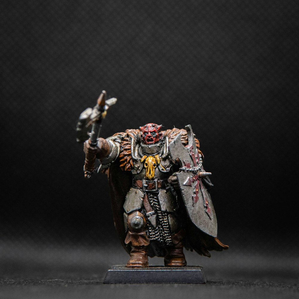 a painted warhammer with a sword and shield