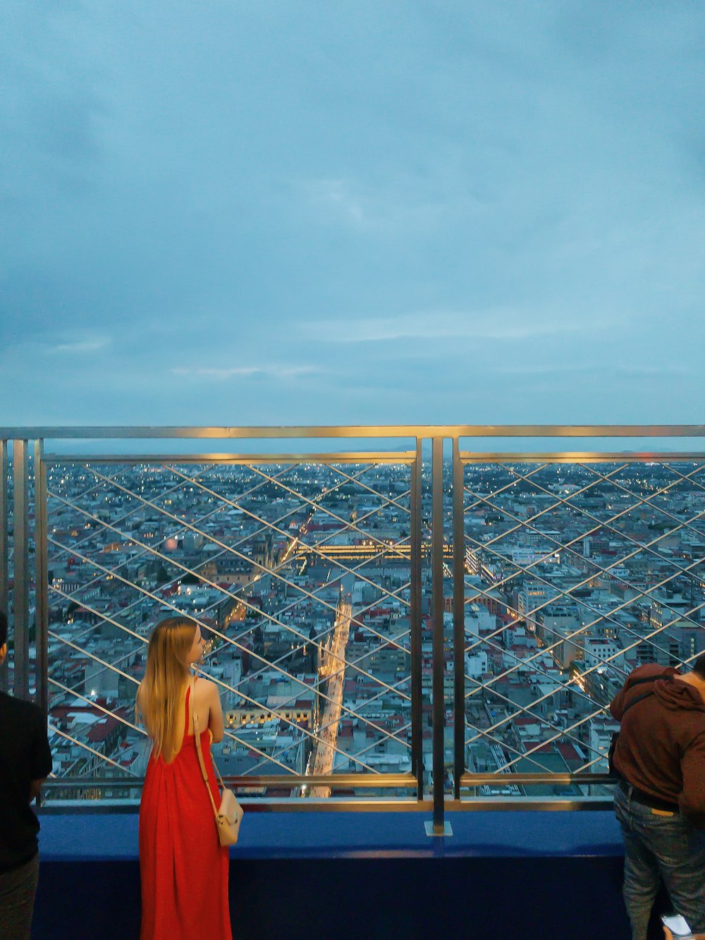 a couple of people standing on top of a tall building