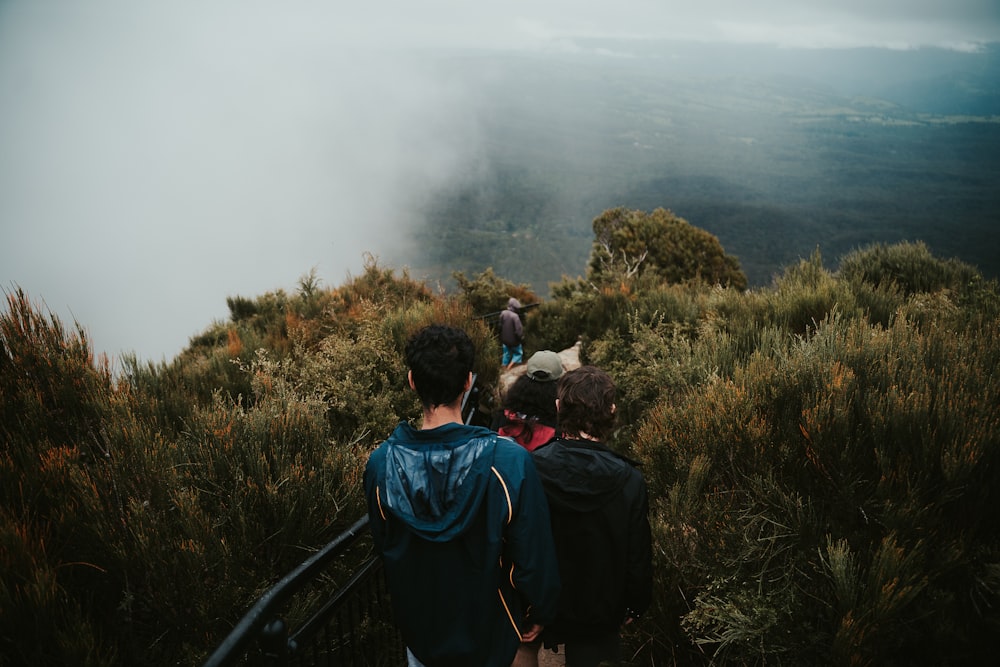 a group of people walking up a hill