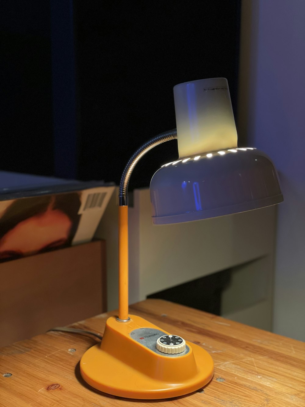 a desk lamp sitting on top of a wooden table