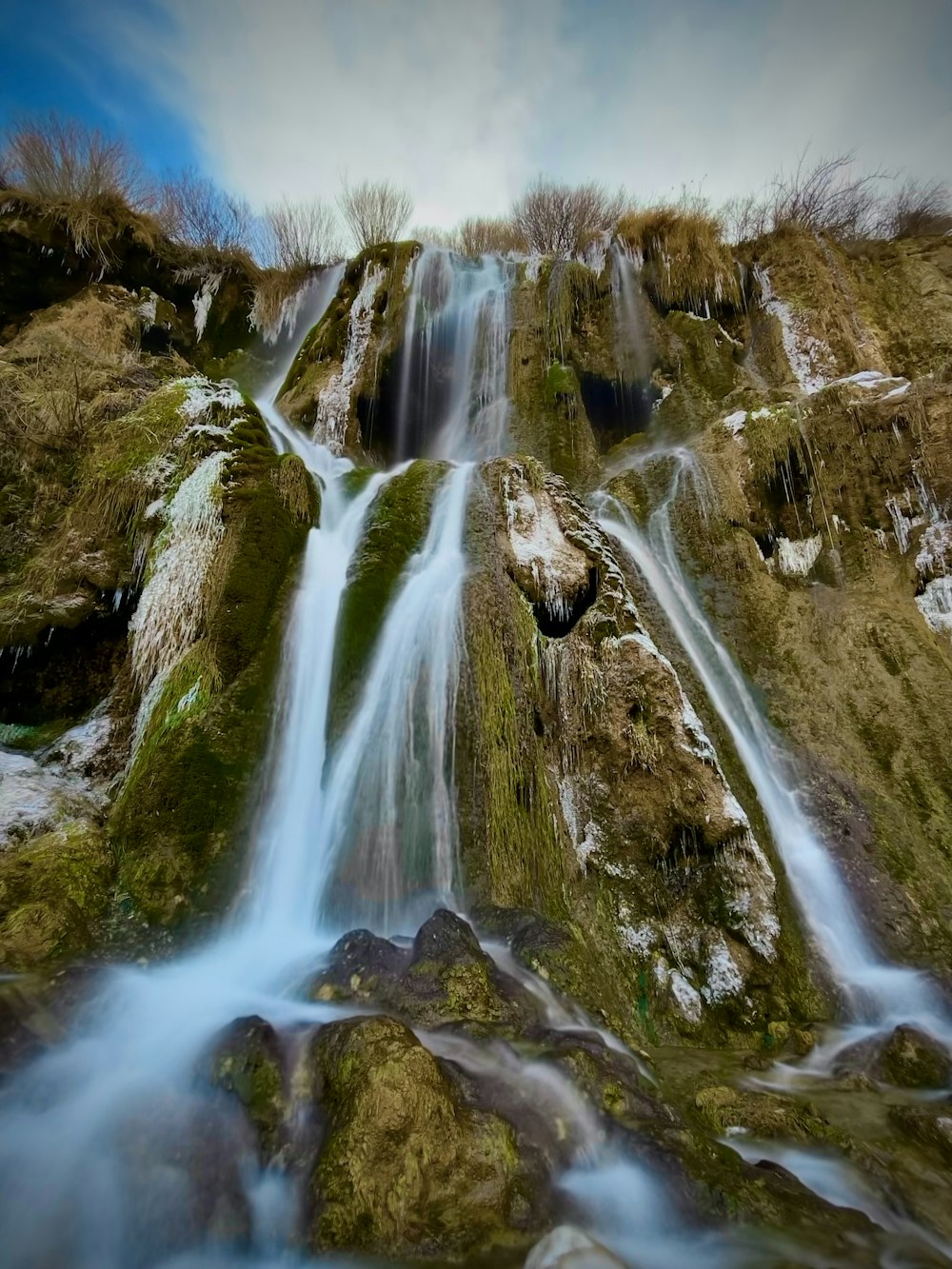 a very tall waterfall with lots of water