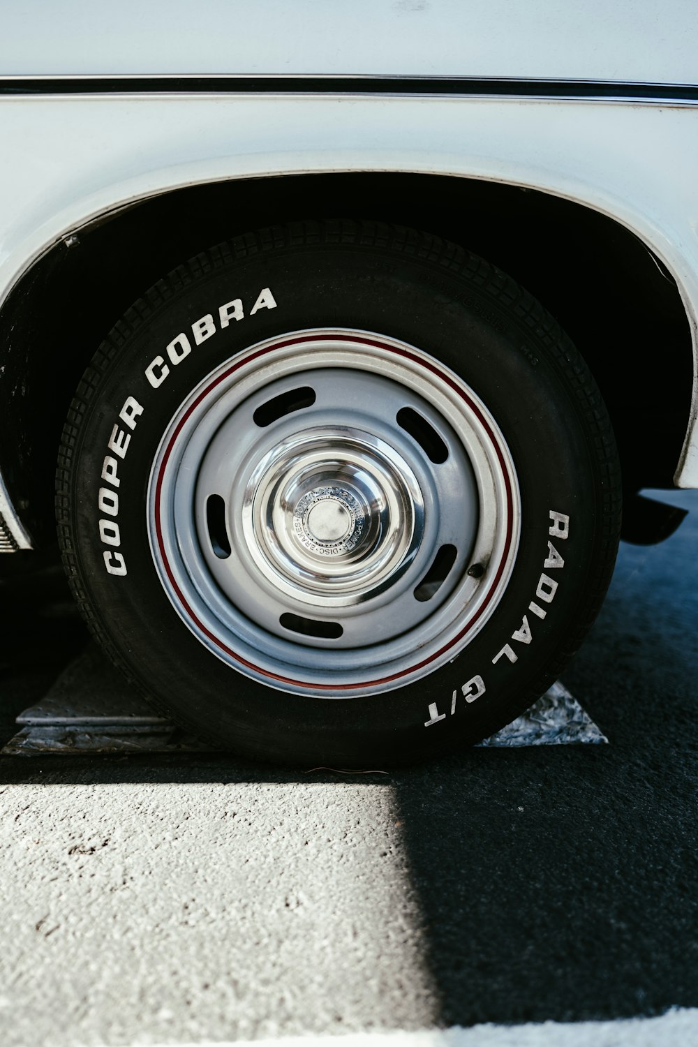 a close up of a tire on a white car