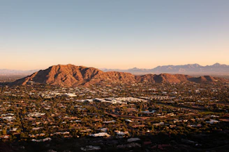 an aerial view of a city with mountains in the background