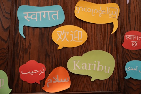 A group of colorful speech bubbles on a wooden wall