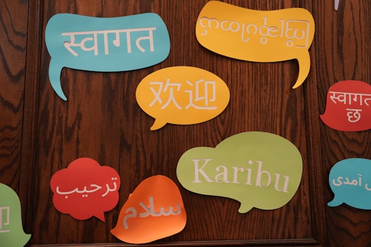A group of colorful speech bubbles on a wooden wall