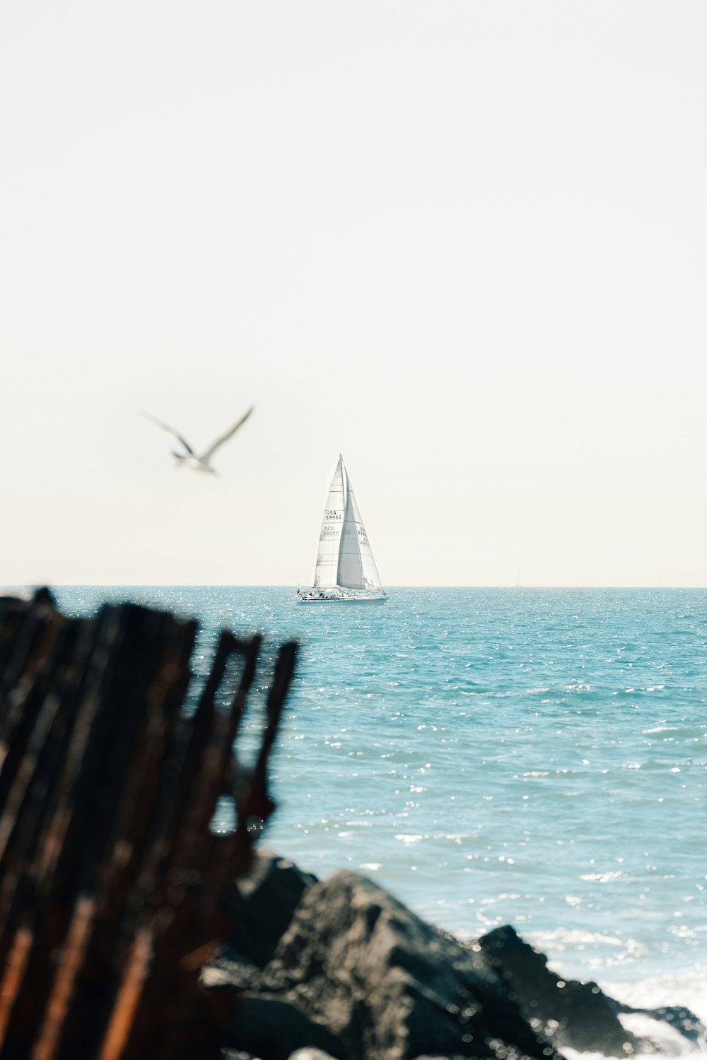 a sailboat is in the distance on the ocean