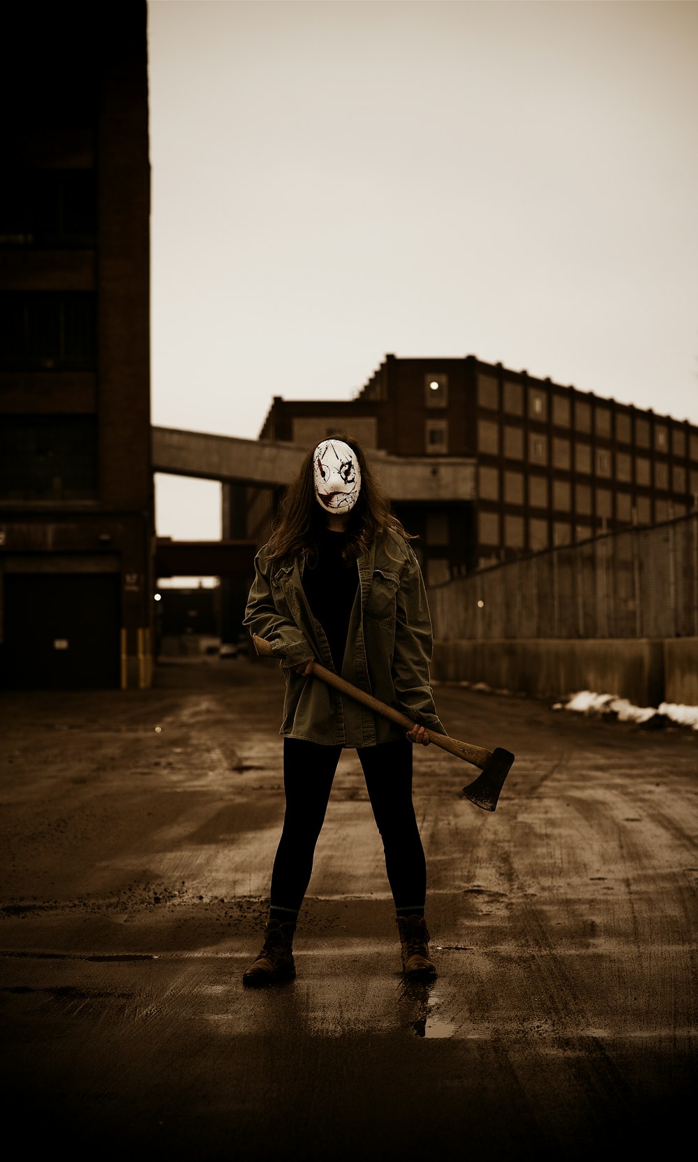 a person with a mask holding a broom