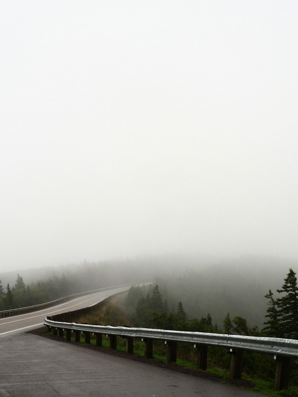 a foggy day on a highway with a stop sign