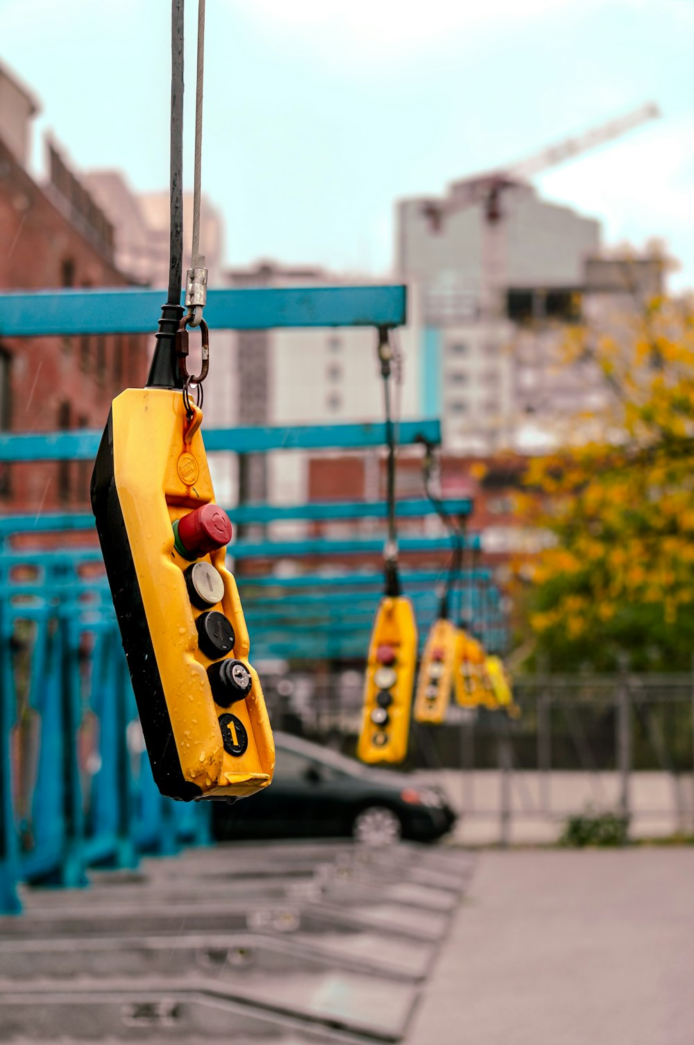 a yellow school bus hanging from a crane