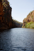 a body of water surrounded by mountains and trees