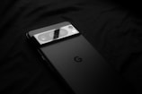 a close up of a cell phone on a black surface