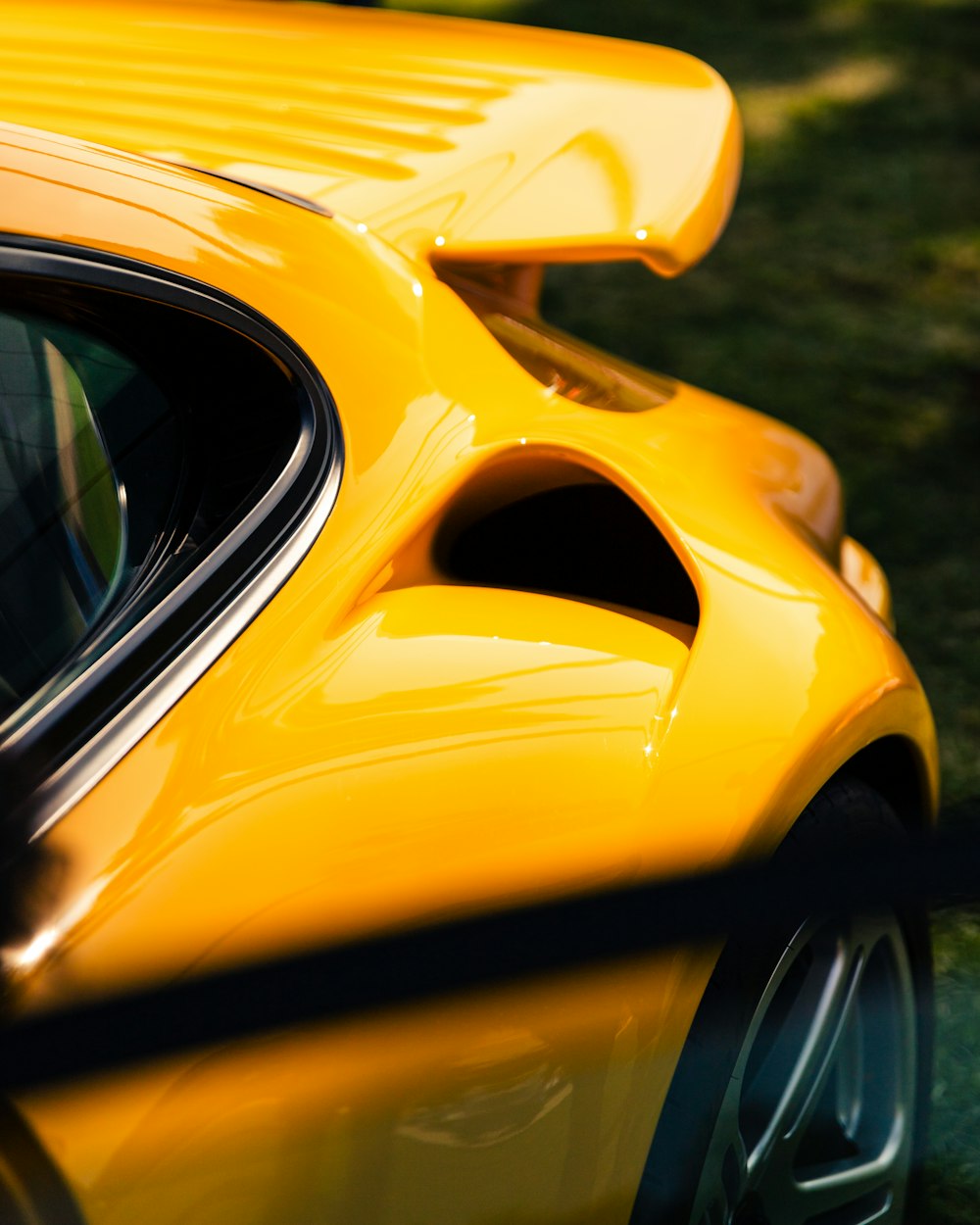 a close up of a yellow sports car