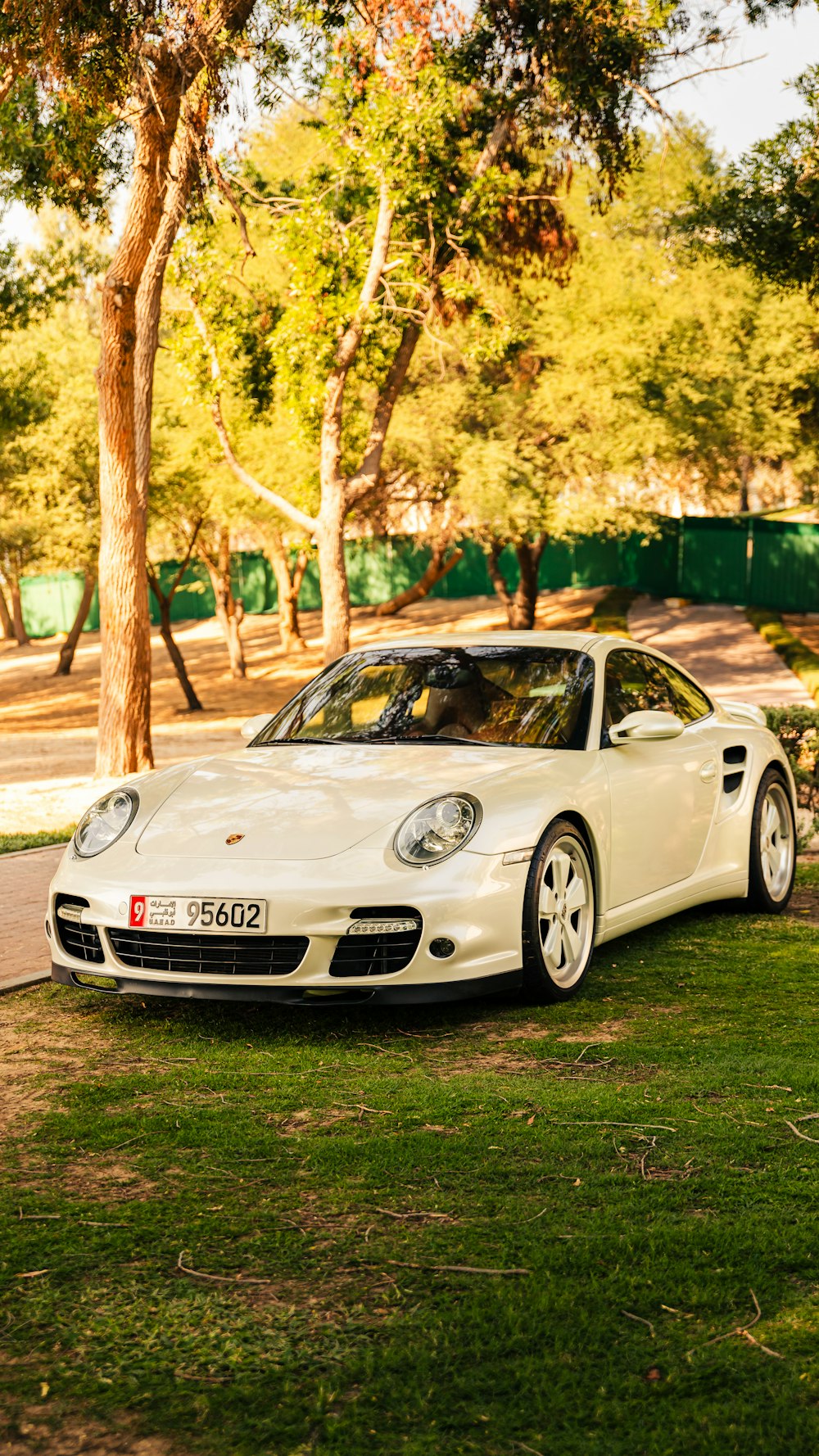 a white sports car parked on the side of the road