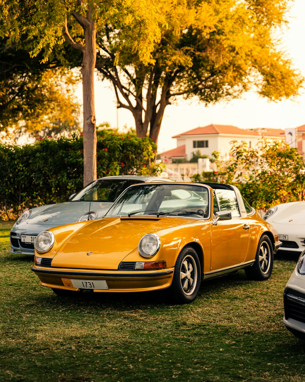 a couple of cars parked next to each other on a field