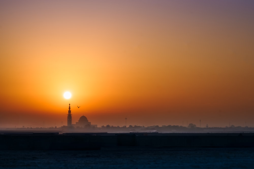 the sun is setting over a city skyline