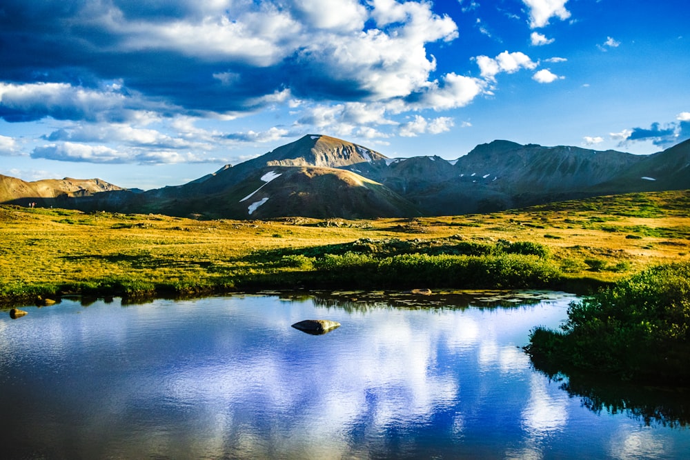 a mountain range with a lake in the foreground