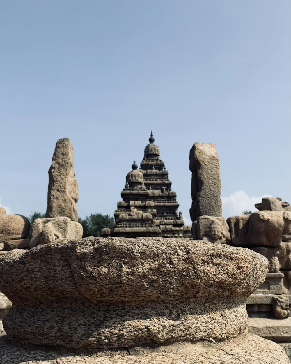 a large rock with a statue on top of it