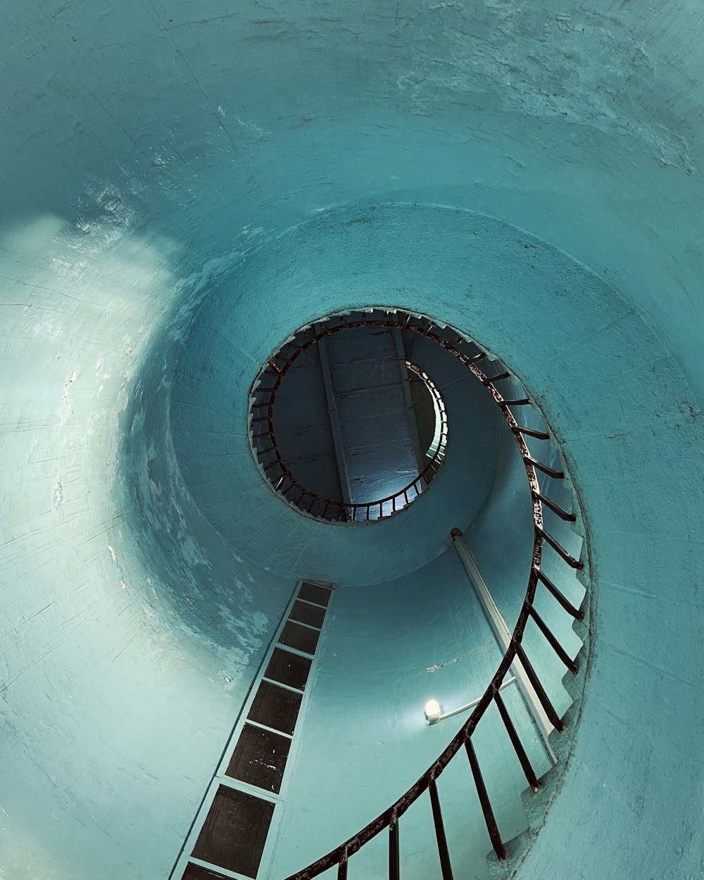 a spiral stair case in a swimming pool