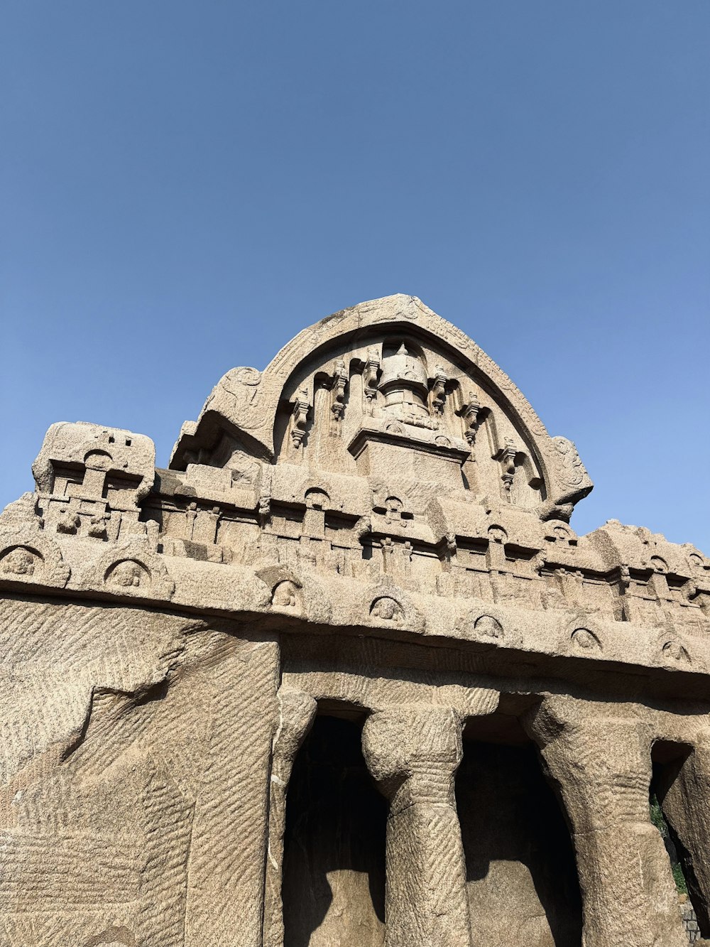 a large stone structure with a sky in the background