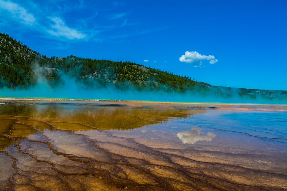 a body of water with steam rising from it