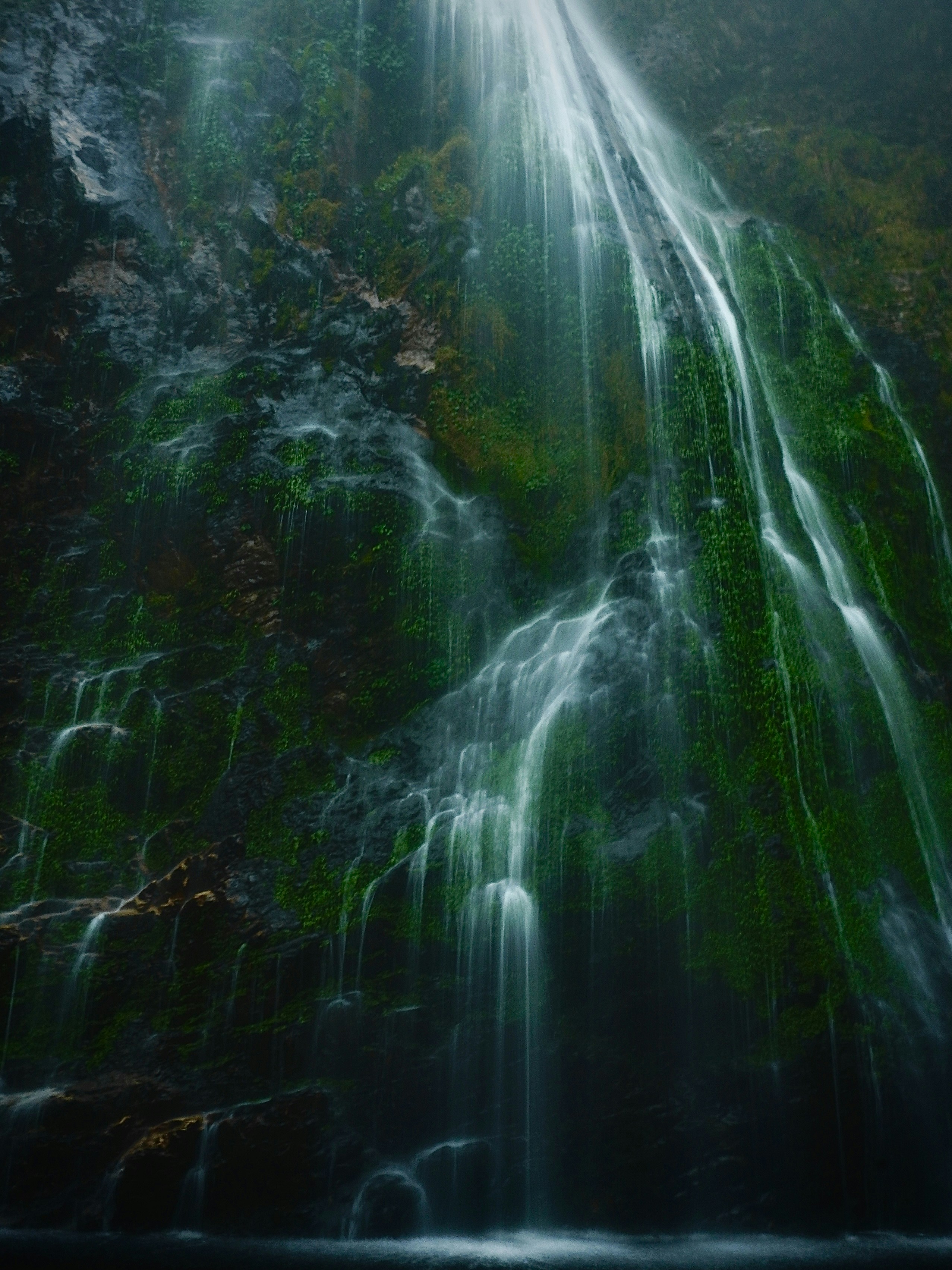 a very tall waterfall with lots of water