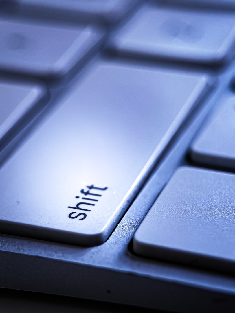 a close up of a keyboard with the word shift on it