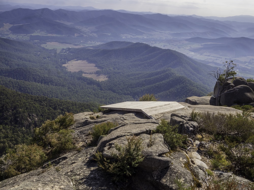 a bench sitting on top of a rocky hillside