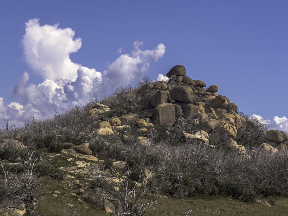 a large rock formation on the side of a hill