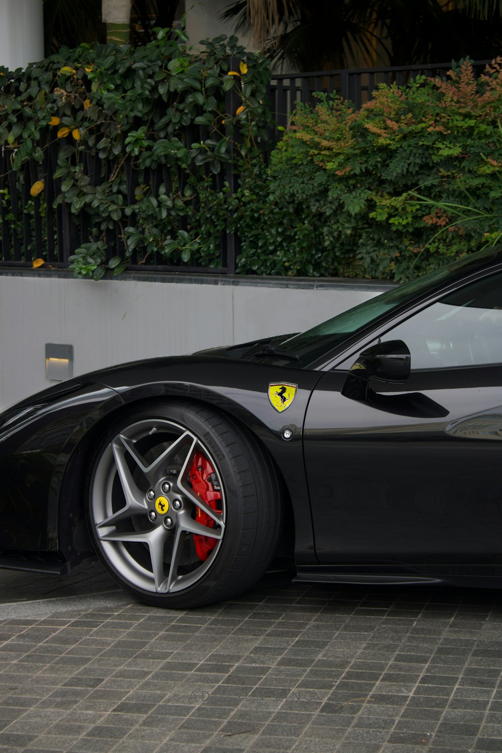 a black sports car parked in front of a building