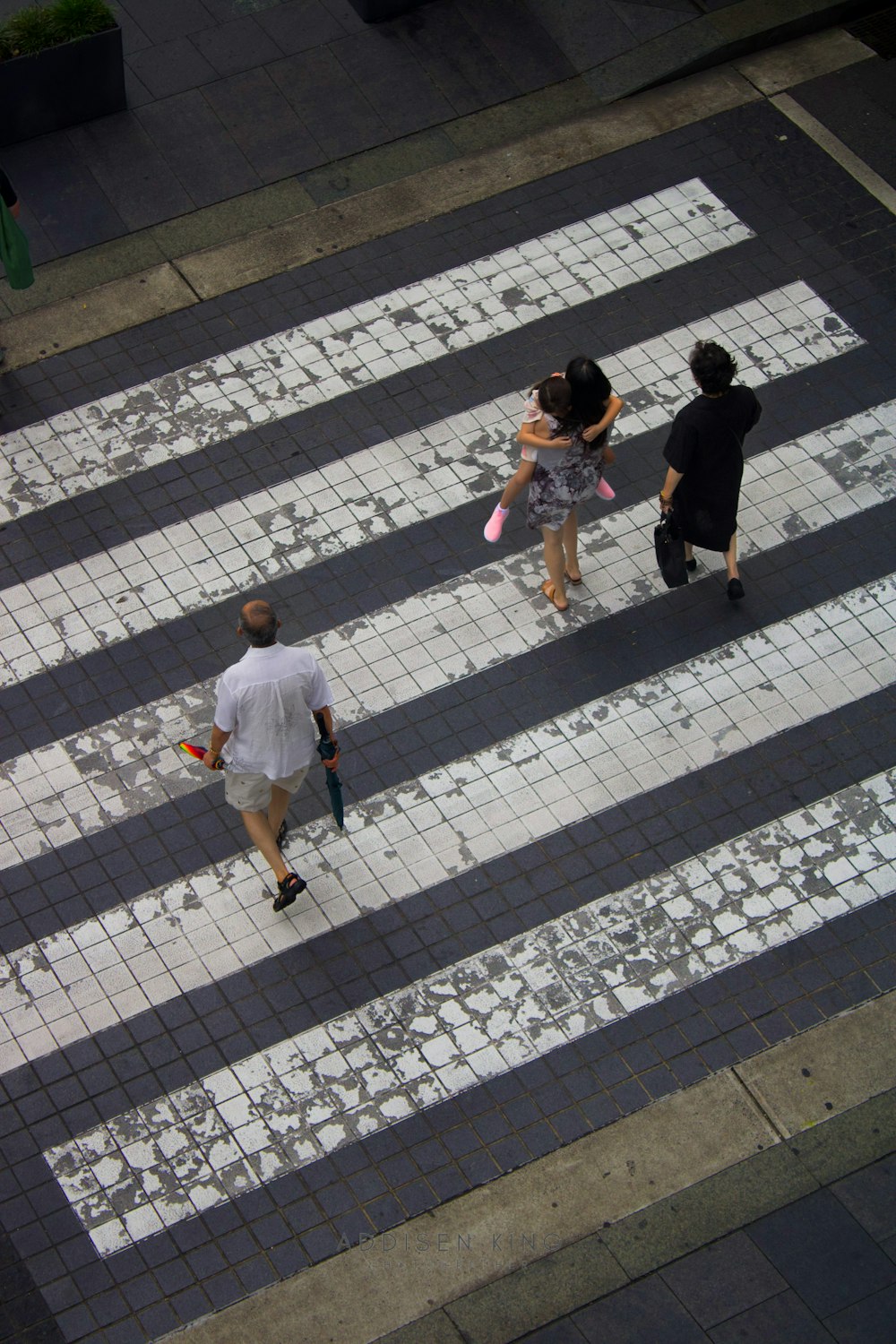 a couple of people walking across a cross walk