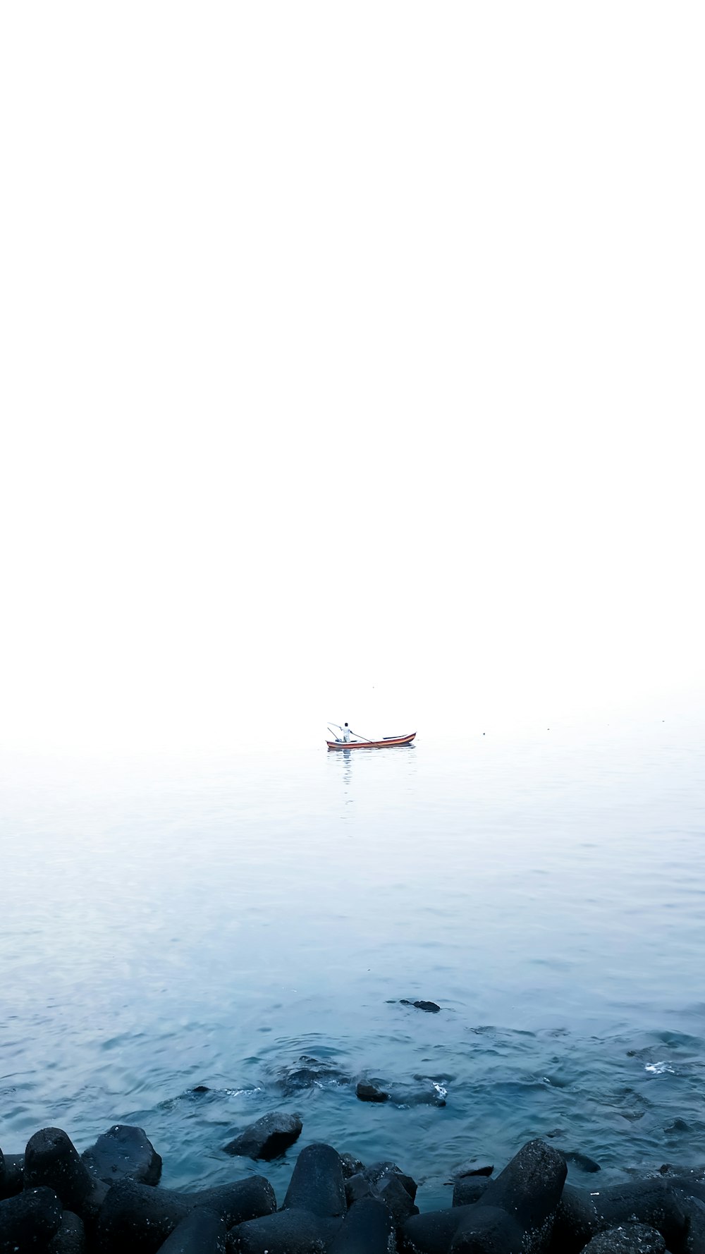 a boat is in the distance on a foggy day