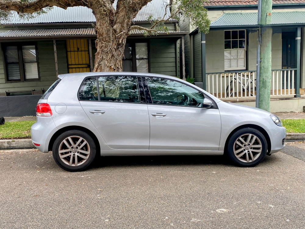 a silver car parked in front of a house