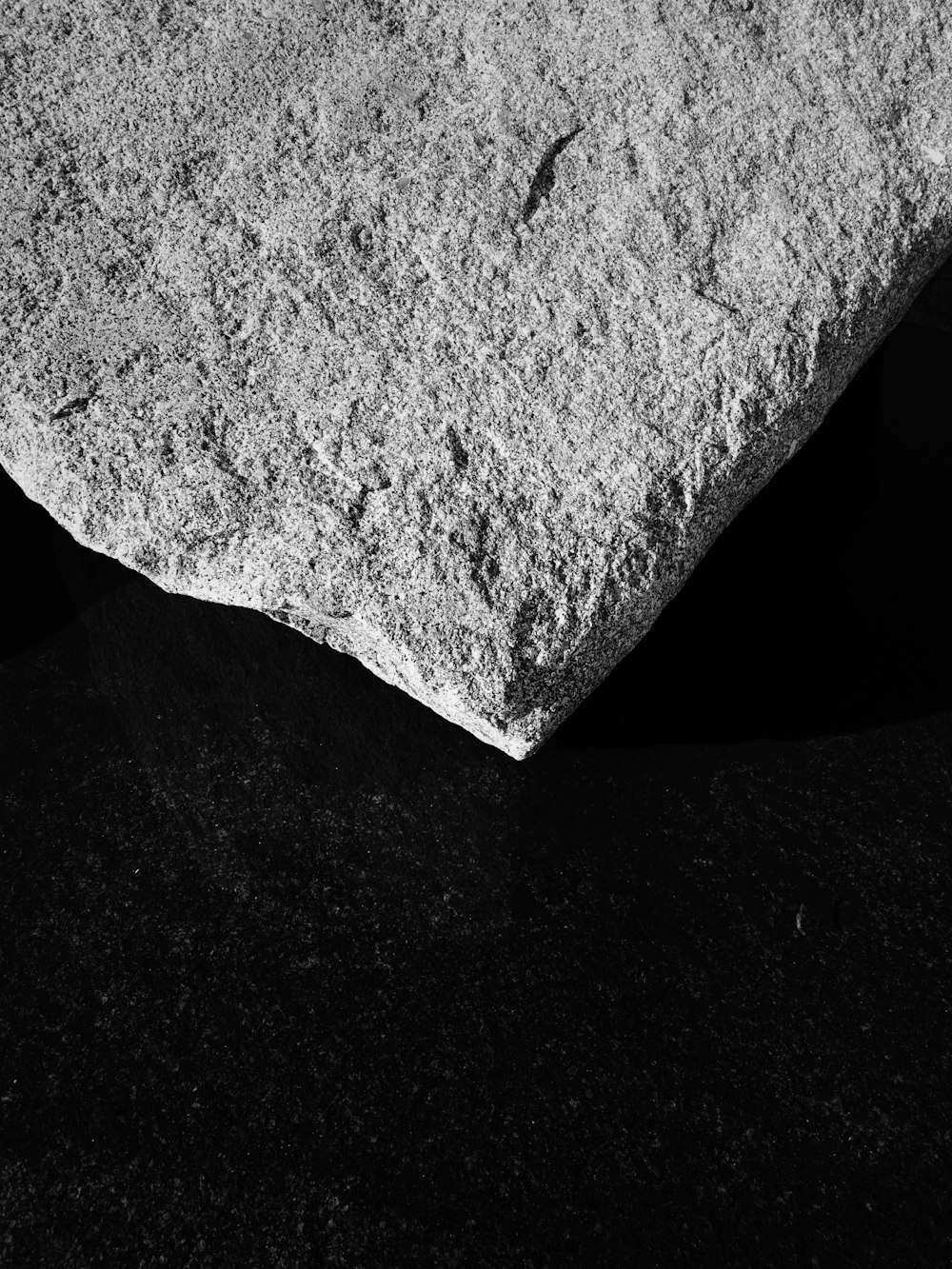 a black and white photo of a rock