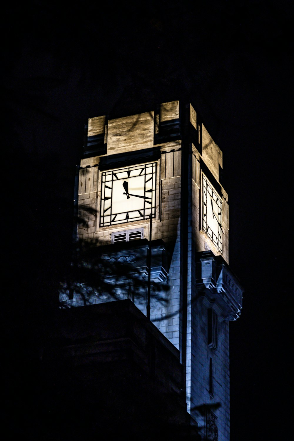 a large clock tower lit up at night