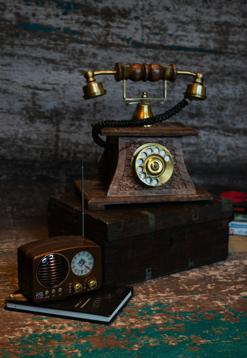 an old fashioned phone sitting on top of a wooden box