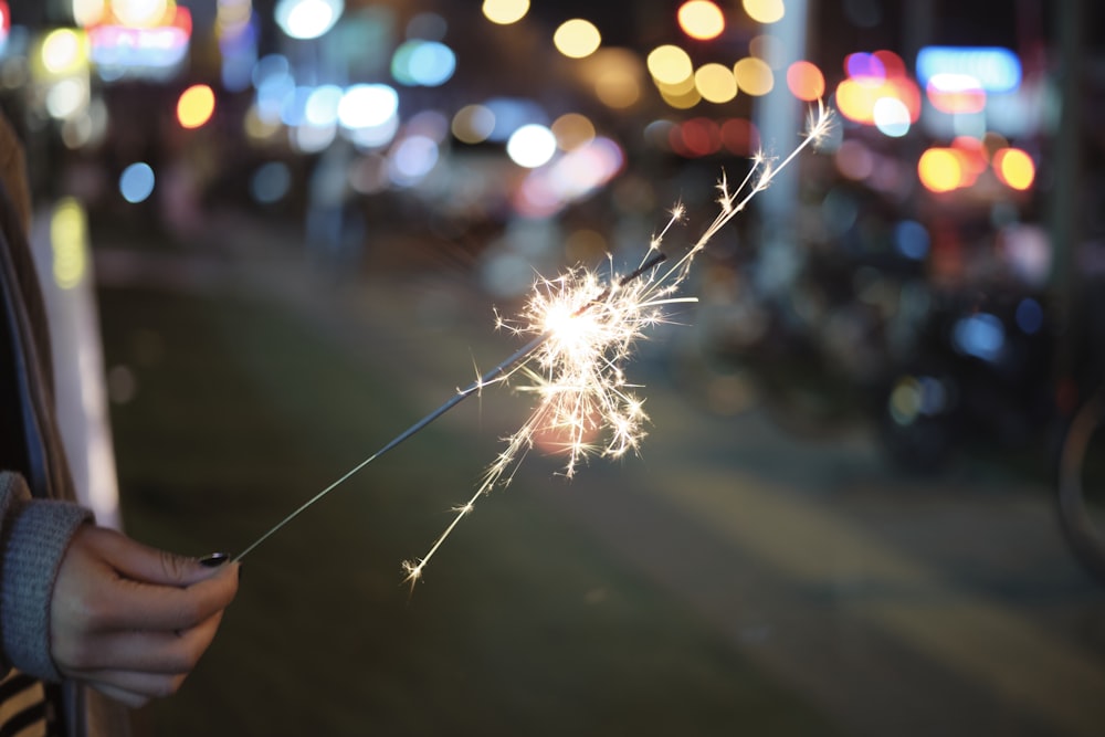 a person holding a sparkler in their hand