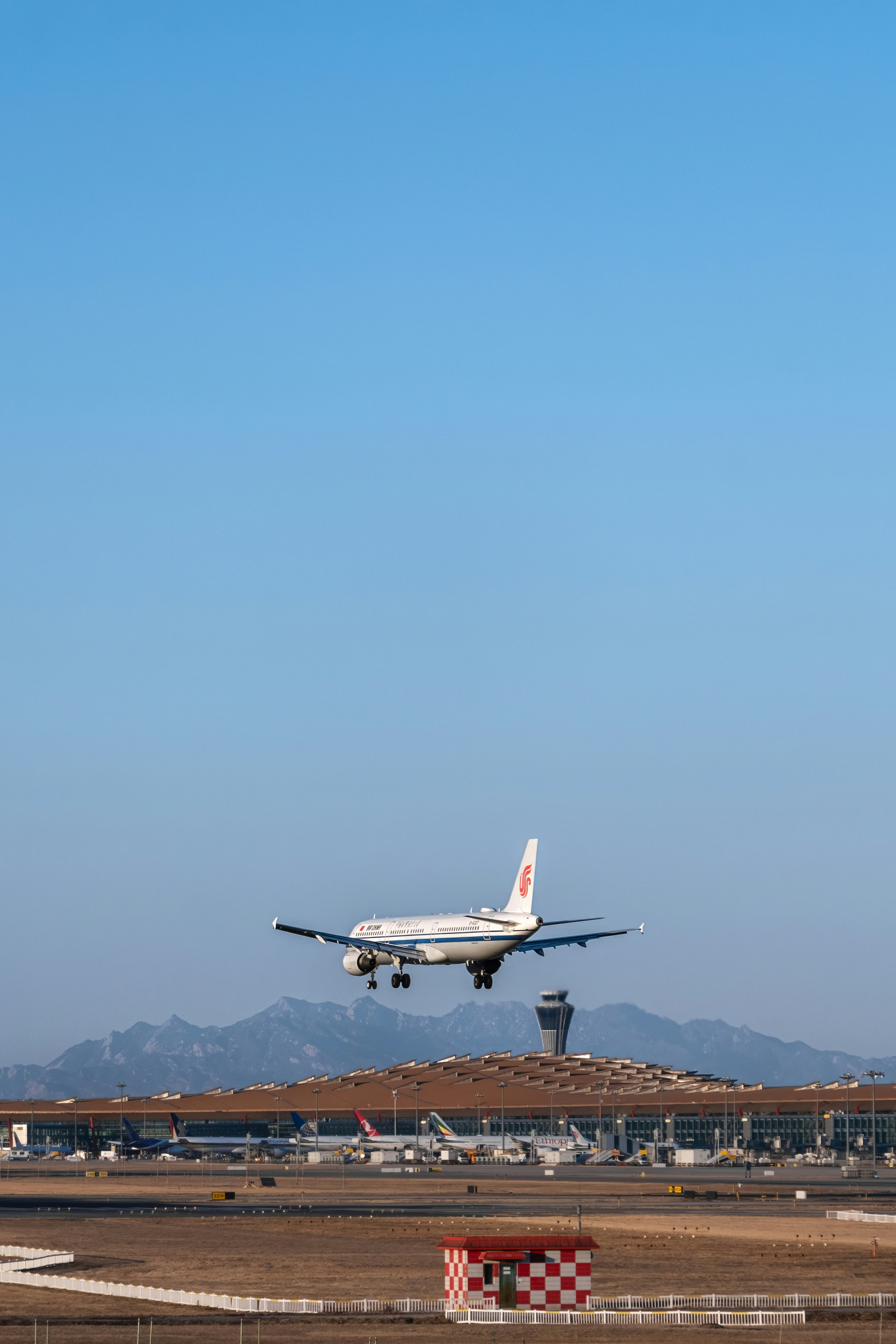 a large jetliner flying through a blue sky