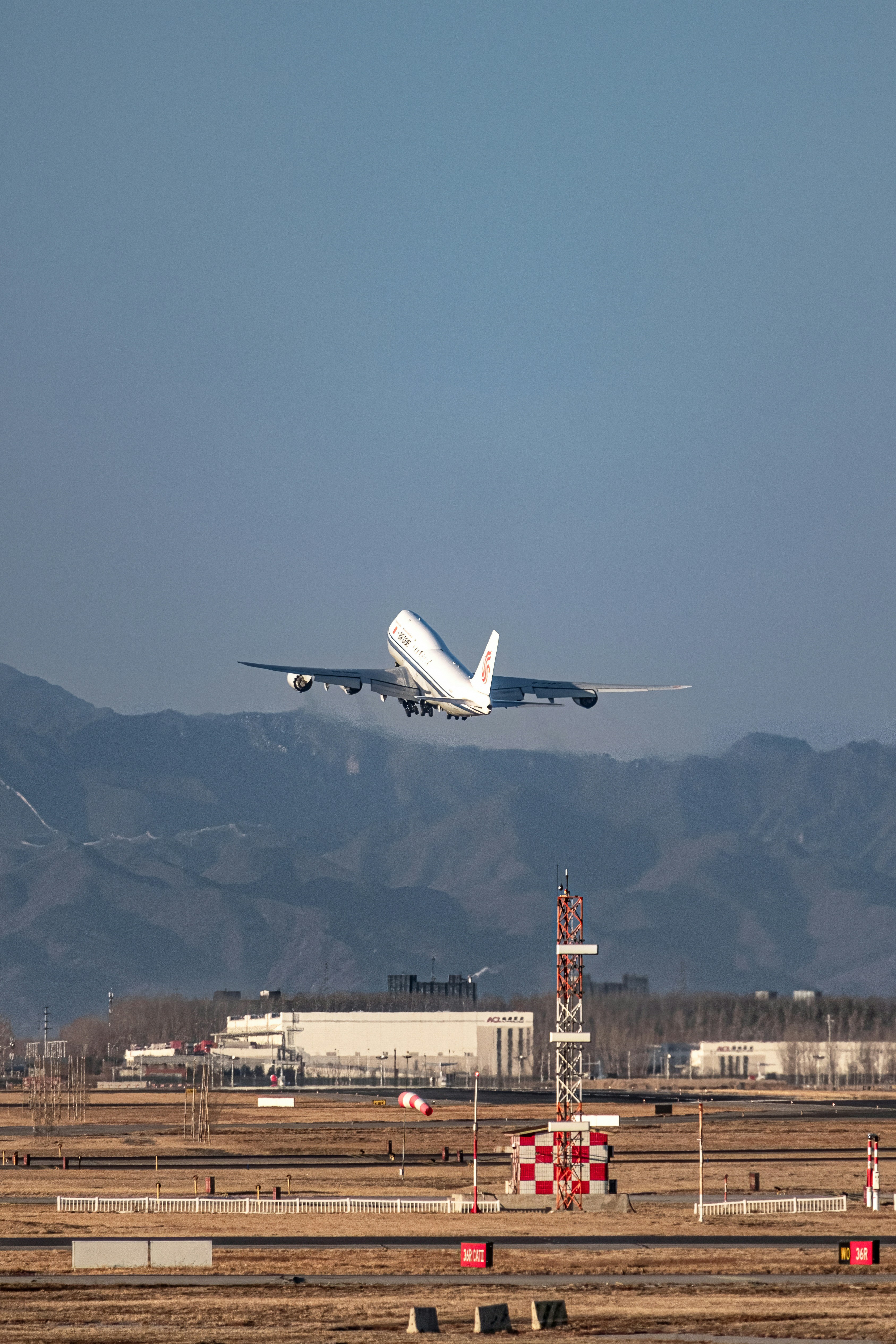a large jetliner flying through a blue sky