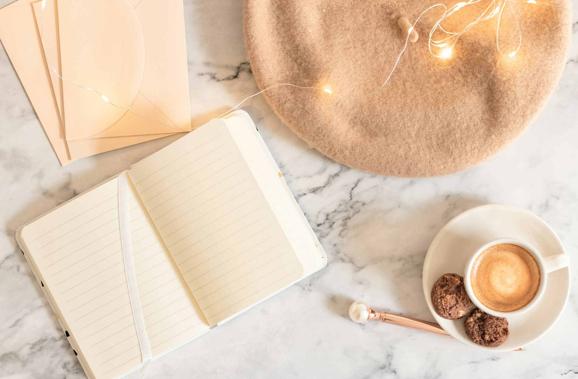 a cup of coffee and a notebook on a marble table