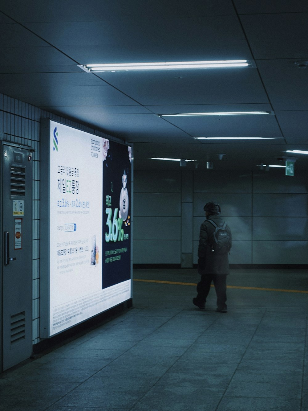 a person standing next to a large screen in a building