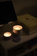 a couple of candles sitting on top of a table