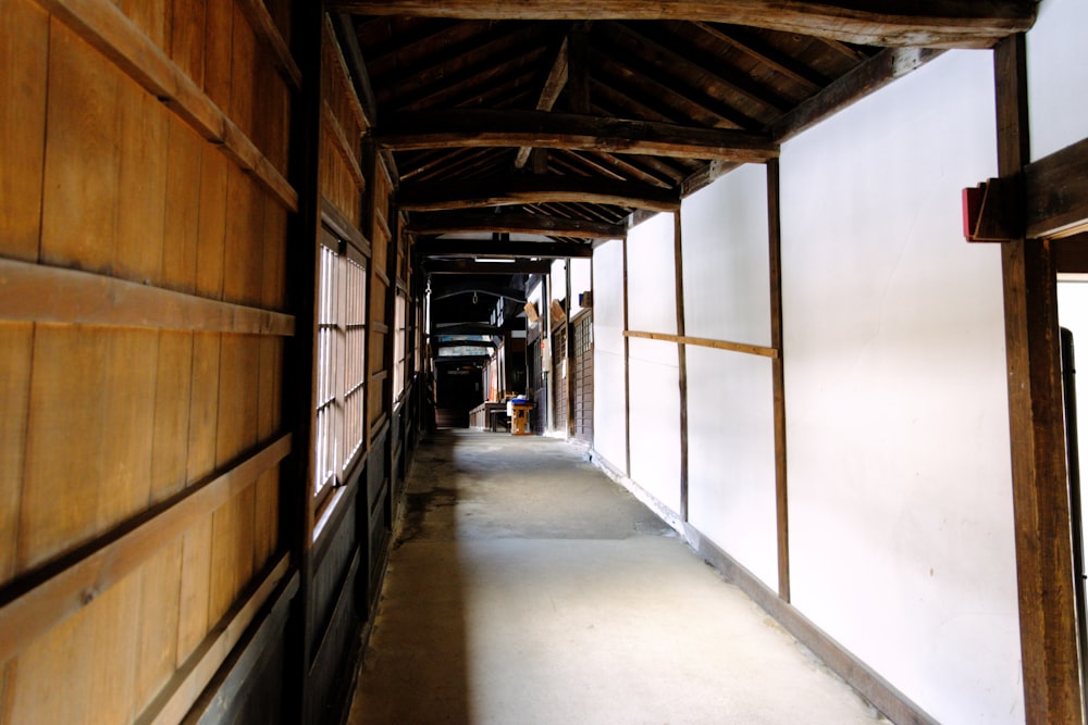 a long narrow hallway with wood paneling and white walls