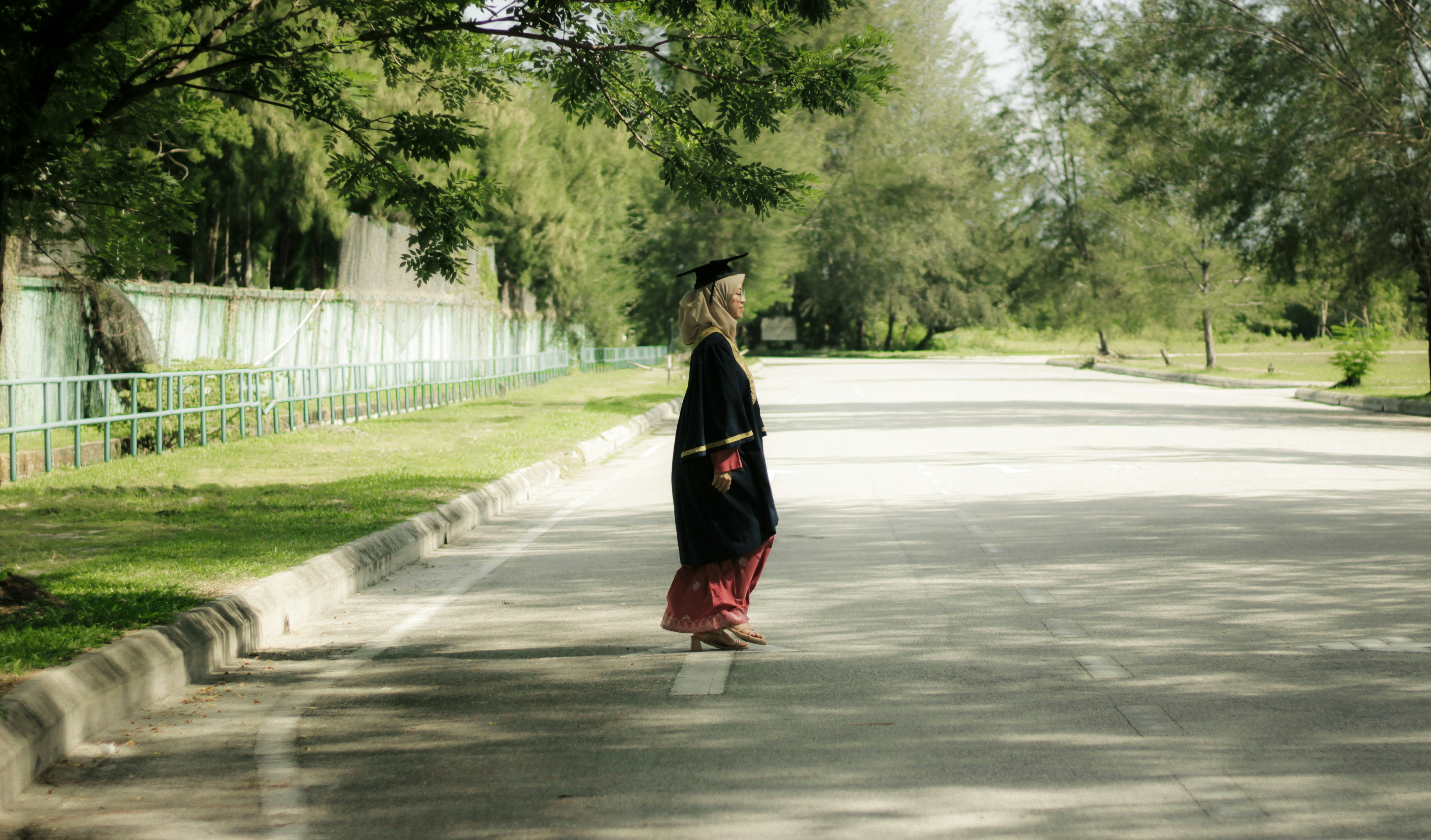 a person walking down a street with a hat on