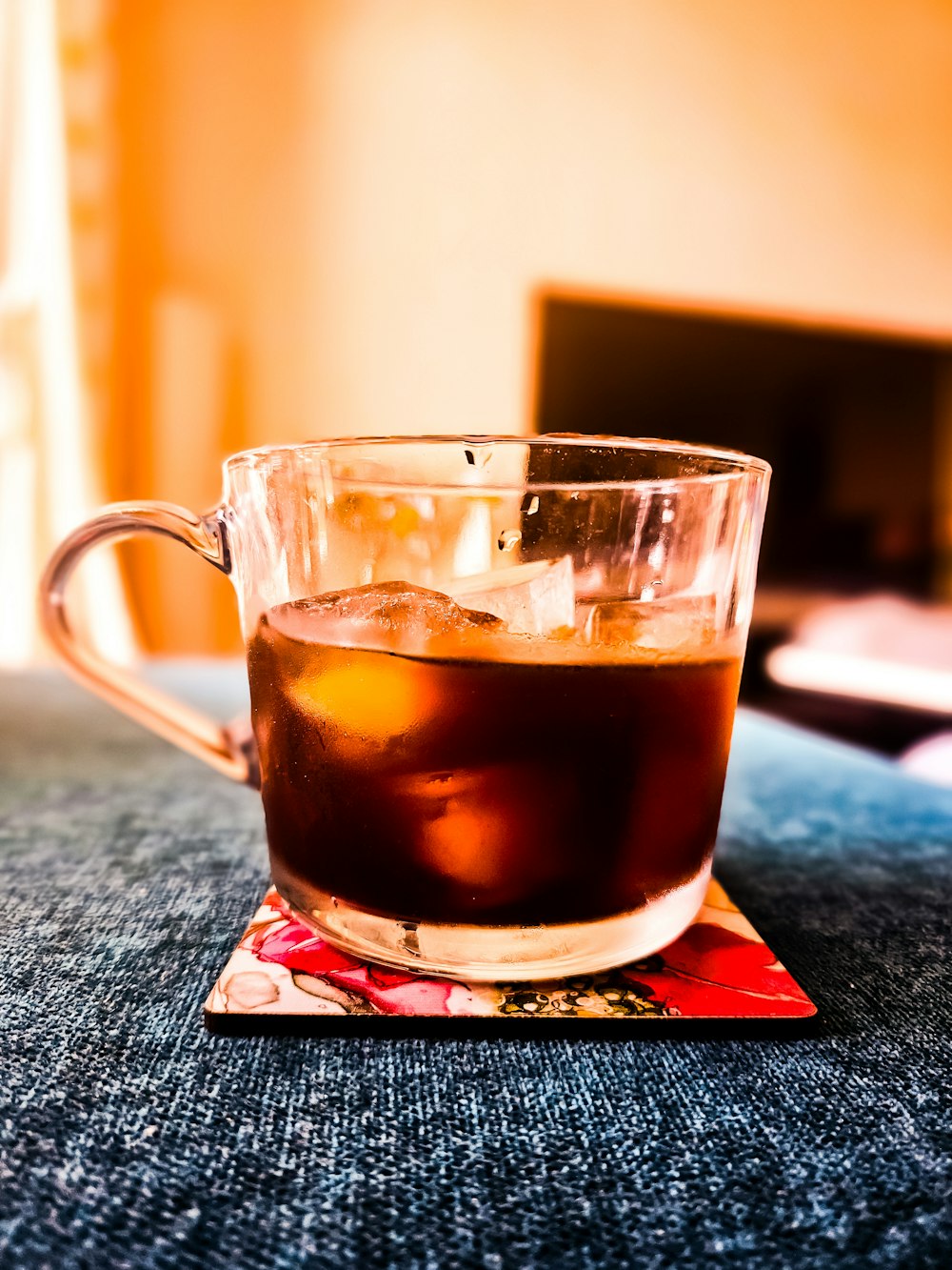 a glass of tea sitting on top of a table