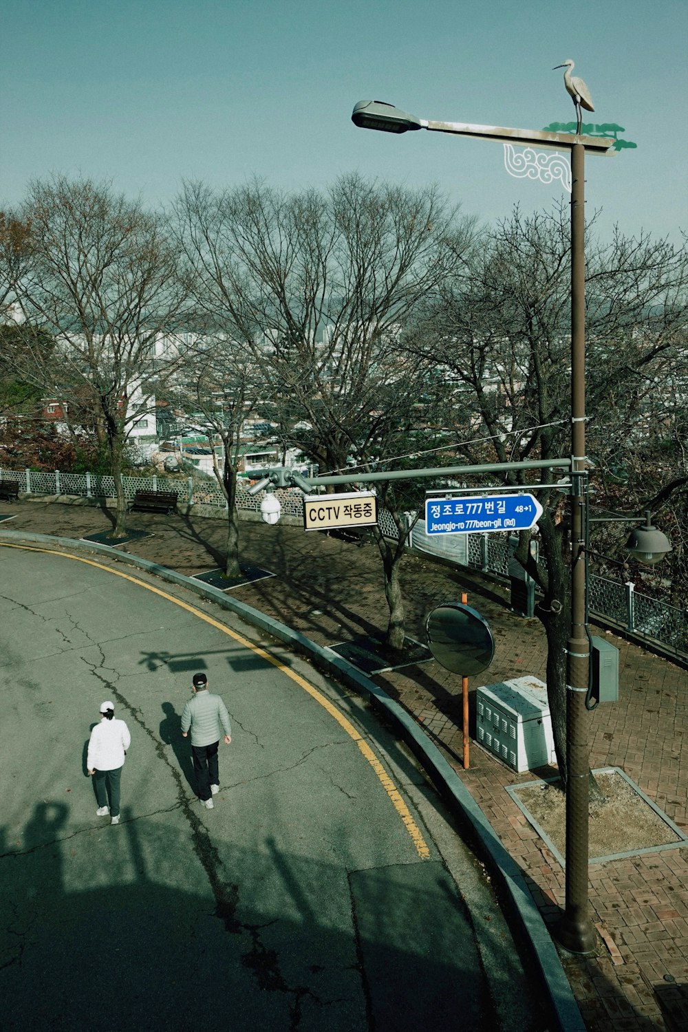 a couple of people walking down a street