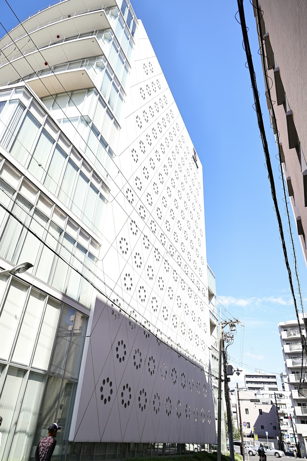 a tall white building sitting next to a tall building